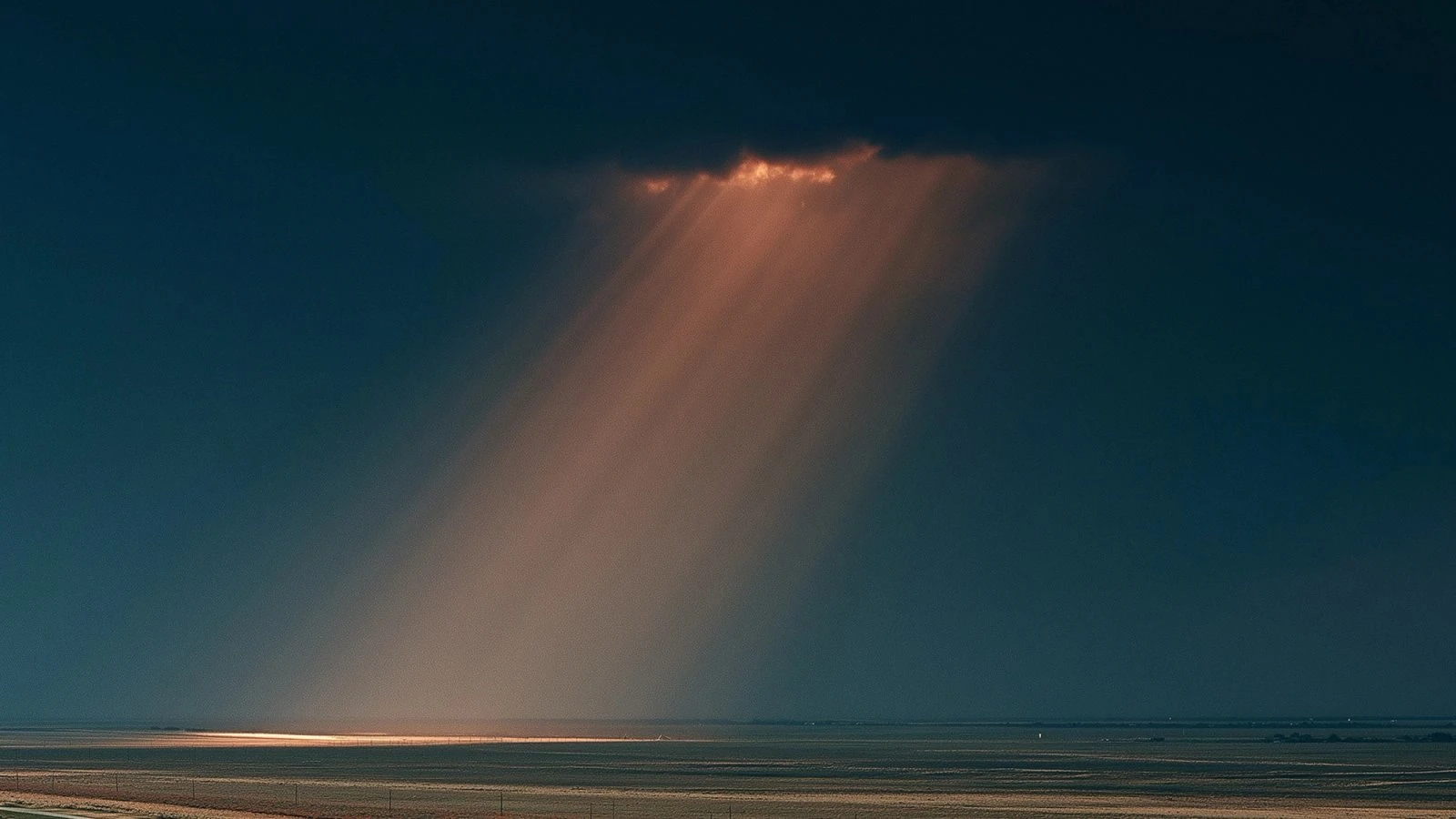 Generated banner: a sunbeam breaking through clouds over the ocean